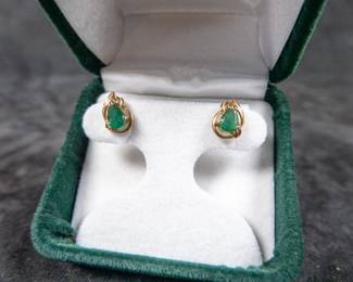 A set of stunning vintage 14K gold earrings with Emeralds. Marked 14K on earring backs. Total approx. weight of 1.40 grams. Comes in a green velvet box.