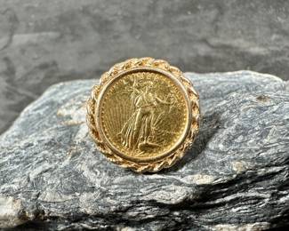 A 14k gold ring with a 1/10 oz. American Gold Eagle coin as the centerpiece. Total approx. weight is 7.92 grams. Ring is a size 8.