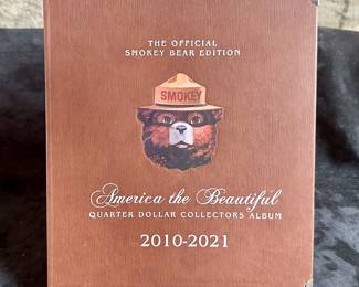 The Official Smokey Bear Edition America the Beautiful Quarter Dollar Collectors Album, partially complete. 81 quarters in total.