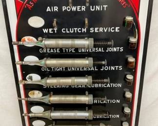 CLOSE UP WITH GREASE GUNS AND JARS 