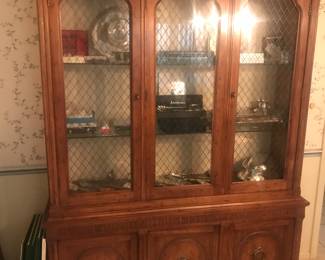 Matching wood china cabinet filled with serving pieces!