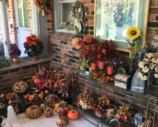 Large selection of holiday decor, that season is coming soon! Wall art above a glass topped 2 shelf console table!