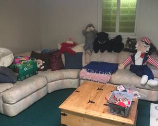 Sectional in lower level. Unique coffee table has hinged tops on each side for storage!