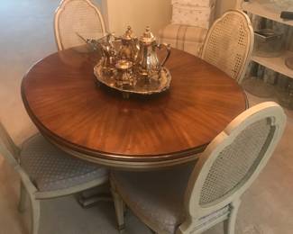 Beautiful dining room tale with pads and 2 leaves also has 6 cane back cushioned chairs!