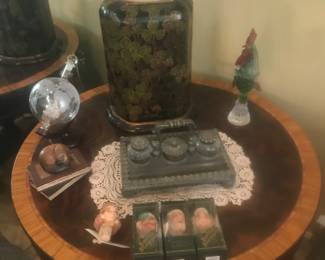 4 drawer round table with inlay and its on wheels too! Unique bottle stoppers and decor on top!