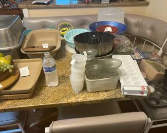 Assortment of kitchen utensiles, Pampered Chef baking stones, pans, Kitchen Aid mix, Commerical grade electric meat slicer and more...
