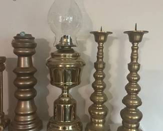 A collection of more than 25 brass candlesticks