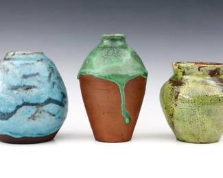 Three 20th century Jugtown Pottery vases.  Egg and baluster forms with Chinese Blue, mottled Green, and Iridescent Chartreuse glazes.  Impressed "Jugtown Ware" marks.  Egg vase with chip at rim, Green vase with crazing, firing cracks at rim and several flakes at body.  4 3/4" to 6 1/2" high.  ESTIMATE $50-100  