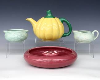 Three pieces of early and mid 20th century Weller Art Pottery.  Includes a signed bowl form vase with flower frog insert and Mauve glaze, a signed "Pierre" creamer and sugar set with basket weave decoration and Light Blue glaze, and an attributed Pumpkin form teapot with Yellow and Green glaze.  Vase and set with "Weller" marks, teapot unmarked.  Minor wear, some crazing, sugar with chip at rim, creamer with short hairline at rim.  Up to 9 1/2" diameter and 6" high.  ESTIMATE $50-100