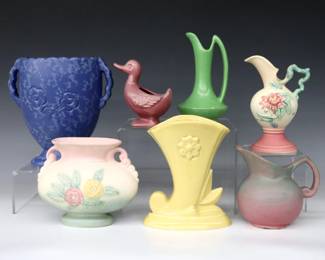 Seven pieces of 20th century American Art Pottery.  Includes a Red Wing vase with incised floral decoration and Blue sponge glaze, an Abingdon cornucopia vase with Yellow glaze, a Hull "Woodland" ewer and "Open Rose" pillow vase with multi-color floral decoration and Pink/Green glaze, with a Niloak ewer, creamer and Duck form planter with Mauve and Green matte glaze.  Each with maker's marks, Abingdon vase and Niloak ewer with original foil labels.  Some surface wear, slight crazing, ewer with flake near foot.  4 1/2" to 7 1/2" high.  ESTIMATE $50-100