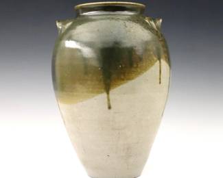 A 20th century Jugtown Pottery vase.  Chinese style urn form with applied handles and mottled Green drip glaze.  Impressed "Jugtown Ware" mark.  Minor wear, flake at handle, production glaze imperfection at body.  9 1/2" high.  ESTIMATE $100-200