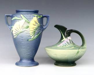 Two pieces of mid 20th century Roseville Art Pottery with multi-color Freesia decoration.  Includes a tapered vase with two handles and Blue matte glaze, and a bulbous ewer with curved handle and graident Green matte glaze.  Molded "Roseville / U.S.A" marks, vase with "121-8" and ewer with "19-6" model numbers.  Minor wear, ewer with some staining to interior.  7 3/4" and 10 1/4" high.  ESTIMATE $50-100