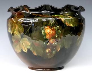 A turn of the century Weller Louwelsa Art Pottery jardiniere.  Bulbous form with ruffled rim, multi-color Grape Vine decoration and Brown Standard glaze.  Impressed "Weller Louwelsa" and "219" marks at underside, artist signature "A. Haubrich" (Albert Haubrich, American, 1875–1931) at body.  Crazing and minor surface wear.  13" diameter x 10 3/4" high.  ESTIMATE $50-100