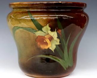 A turn of the century Weller Louwelsa Art Pottery jardiniere.  Flared form with multi-color Daffodil decoration and Brown Standard glaze.  Impressed "Weller Louwelsa" and "88" marks at underside, artist initials "CR" (n.d.) at body.  Crazing and minor surface wear.  12" diameter x 10 1/4" high.  ESTIMATE $50-100