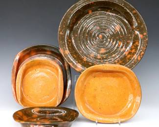 Five 20th century Jugtown Pottery dishes.  Circular and oval forms with mottled Orange and Green/Orange Accidental glazes.  Includes a pie dish and four dishes with folded side handles.  Impressed "Jugtown Ware" marks.  Crazing, some flakes and surface wear.  Up to 9 1/4" long and 11 3/4" diameter.  ESTIMATE $50-75