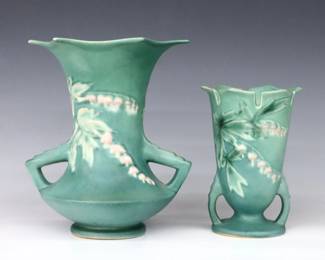 Two mid 20th century Roseville Art Pottery vases with multi-color Bleeding Heart decoration and Green matte glaze.  Both footed vases with flared form and two low handles.  Molded "Roseville / U.S.A" marks, larger with "969-8" and smaller with "964-6" model numbers.  Minor wear and discoloration.  6 1/4" and 8 1/4" high.  ESTIMATE $50-100