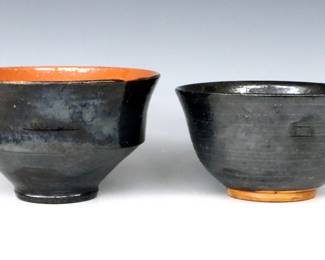 Two 20th century Jugtown Pottery bowls.  Footed forms with Metallic Black and Red glaze.  Impressed "Jugtown Ware" marks.  Some crazing and small flakes.  Up to 7 3/4" diameter x 4 1/2" high.  ESTIMATE $50-100