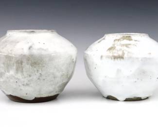 Two 20th century Jugtown Pottery vases.  Bulbous forms with high shoulders and mottled Chinese White glaze.  Impressed "Jugtown Ware" marks.  Minor wear and crazing.  Up to 7" diameter x 5 1/2" high.  ESTIMATE $50-100