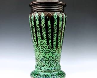 An early 20th century Weller Art Pottery pedestal.  Baluster form with molded geometric decoration mottled Green/Black Majolica glaze.  Impressed "Weller" mark.  Crazing, some surface wear at top, chip to underside.  17 3/4" high.  ESTIMATE $50-100