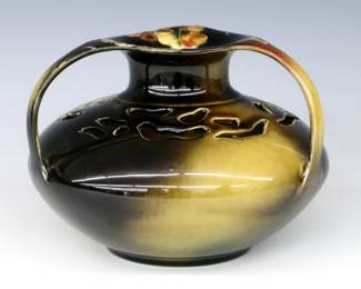 A late 19th century Rookwood Art Pottery vase.  Bulbous form with flared rim, three curved handles and pierced shoulder with multi-color Iris decoration and Brown Standard glaze.  Impressed Rookwood mark with four flames (1890) and incised "W.P. McD" artist signature (William Purcell McDonald, American, 1863-1931).  Minor crazing, small area with glaze imperfection near foot.  7" diameter x 5" high.  ESTIMATE $50-100