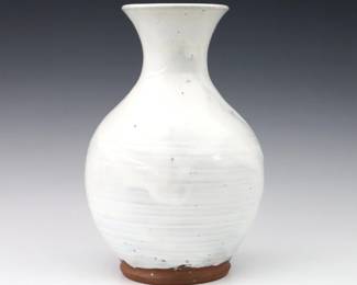 A 20th century Jugtown Pottery vase.  Baluster form with incised decoration and Chinese White glaze.  Impressed "Jugtown Ware" mark.  Minor wear.  9 3/4" high.  ESTIMATE $50-100