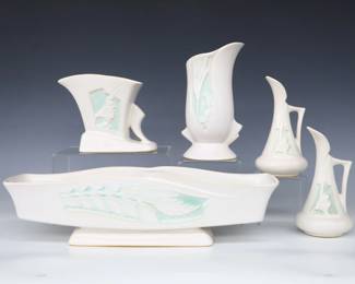 Five pieces of mid 20th century Roseville Art Pottery.  Various forms with Mint Green "Silhouette" foliate decoration, includes a long planter, two vases and pair of ewers.  Molded "Roseville / U.S.A" marks and model numbers.  Some surface wear.  Up to 15 1/4" long and 7 1/4" high.  ESTIMATE $100-150