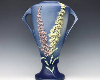 A large mid 20th century Roseville Art Pottery vase.  Baluster form with two handles, multi-color Foxglove decoration and Blue matte glaze.  Molded "Roseville / U.S.A" mark and "55-16" model number.  Some crazing, hairline at rim.  16 1/2" high.  ESTIMATE $50-75