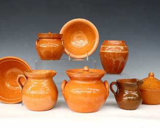 Eight pieces of 20th century Jugtown Pottery.  Various forms with mottled Orange glaze, includes a covered jar, covered pot, pitcher, vase, small covered jar, creamer and two bowls.  Impressed "Jugtown Ware" marks.  Crazing, a couple flakes, covered pot with small chip at lid rim, one with painted underside.  Up to 10 1/4" diameter and 5 3/4" high.  ESTIMATE $50-75