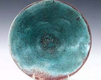 A 20th century Jugtown Pottery bowl.  Footed form with mottled Chinese Blue and Oxblood glaze.  Impressed "Jugtown Ware" mark.  Minor wear.  9 1/4" diameter x 3" high.  ESTIMATE $50-100