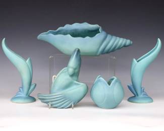 Five pieces of 20th century Van Briggle Art Pottery with "Ming" Blue matte glaze.  Includes a pair of floriform vases, a Conch Shell form dish, a Parrot form wall pocket, and a small Tulip form vase.  Incised Van Briggle marks with "Colo. Spgs." and various numerals.  Some surface wear, marks and minor discoloration.  Up to 12 1/2" long and 8 1/2" high.  ESTIMATE $100-200