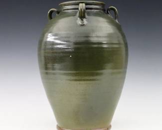A late 20th century Daniel Farrell for Westmoore Pottery vase.  Chinese style urn form with applied handles and mottled Green glaze.  Incised "Westmoore" mark and "Daniel R. Farrell" signature.  Minor wear, a couple small flakes at body.  11" high.  ESTIMATE $50-100