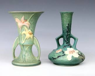 Two mid 20th century Roseville Art Pottery vases with low handles and Green matte glaze.  Includes a flared vase with multi-color Zephyr Lily decoration, and a bottle vase with multi-color Magnolia decoration.  Molded "Roseville / U.S.A" marks, Lily with "132-7" and Magnolia with "179-7" model numbers.  Minor wear and crazing, some interior staining.  Each 7 1/4" high.  ESTIMATE $50-75