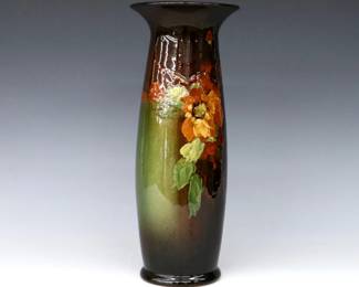 An early 20th century Weller Art Pottery vase.  Tapered form with flared rim and multi-color Wild Rose decoration with Brown Standard glaze.  Impressed "Weller" mark.  Some crazing and minor wear.  12 1/4" high.  ESTIMATE $50-100