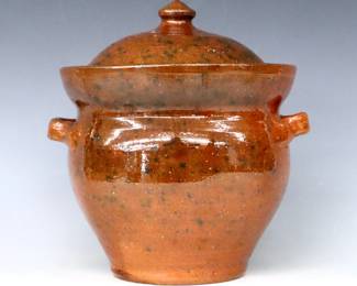 A 20th century Jugtown Pottery covered soup tureen.  Bulbous form with rounded lid, applied strap handles and mottled Orange/Green Accidental glaze.  Impressed "Jugtown Ware" mark.  Minor surface wear and light scratches, a few flakes.  10 1/4" high.  ESTIMATE $50-75