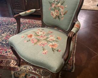 Louis XV Fauteuil chair with needlepoint upholstery.  This is one of two matching chairs that were passed down from her mother's estate 