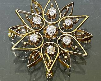 Diamonds Gold Pendant Brooch.  It is 14k yellow gold with seven round F-G in Color,  VS2-SI1 in Clarity diamonds totaling 0.63 carats.  This brooch is  from the Highland Park Estate of an Accomplished woman and is being offered for sale in this Corsicana Estate.