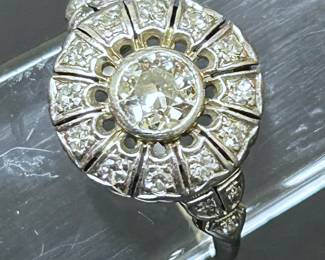 Antique Art Deco platinum ring (4.1 grams) with one 0.6 carats round Color  H-I, Clarity SI1-SI2 diamond surrounded by 18 round G-I Color,   SI-SI2 in Clarity diamonds totaling 0.3carats.   This ring is from the Highland Park Estate of an Accomplished woman and is being offered for sale in this Corsicana Estate.