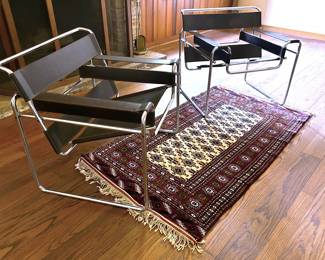 The Wassily chair design originates back to 1926 by designer, Marcel Breuer of the Bauhaus design school of Dessau, Germany.    It has been wildely produced since the 1950s, first by Gavina and then later by Knoll.  Yet, after the patent design date expired, other companies have made their own 'Wassily' styled chairs.      These chairs have no markings, no labels, and the chrome ends are capped instead of flush