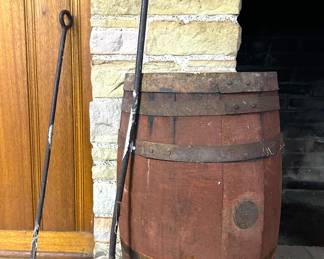 Old ranching branding irons and an old wooden cask barrel 