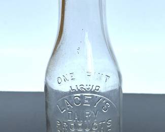 Vintage glass milk bottle by Lacey's Dairy of Palestine, Texas  .....To register so you can place bids go to www.capitolsalesservices.hibid.com 
