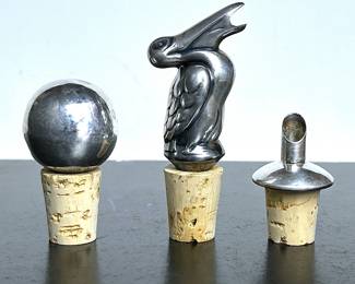 Mid century silver bottle stopper and two pourers  .....To register so you can place bids go to www.capitolsalesservices.hibid.com 