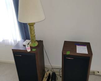 set of stereo speakers, mid century green lamp