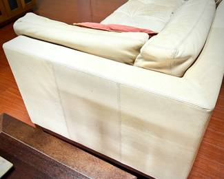 Pale yellow leather tuxedo-style sofa - finished on all sides