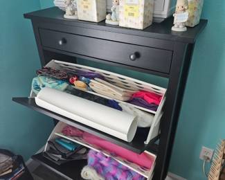 The black storage in it stays with the house.As do the white cabinets hanging on the wall, they stay also not for sale