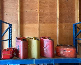 (3) are NATO style Jerry Cans, one smaller metal can with spout, and an Evinrude outboard motor fuel tank