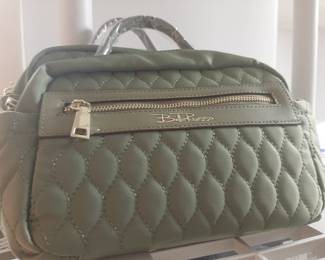 A large selection of Bella Rosso purses, backpacks, totes, and luggage