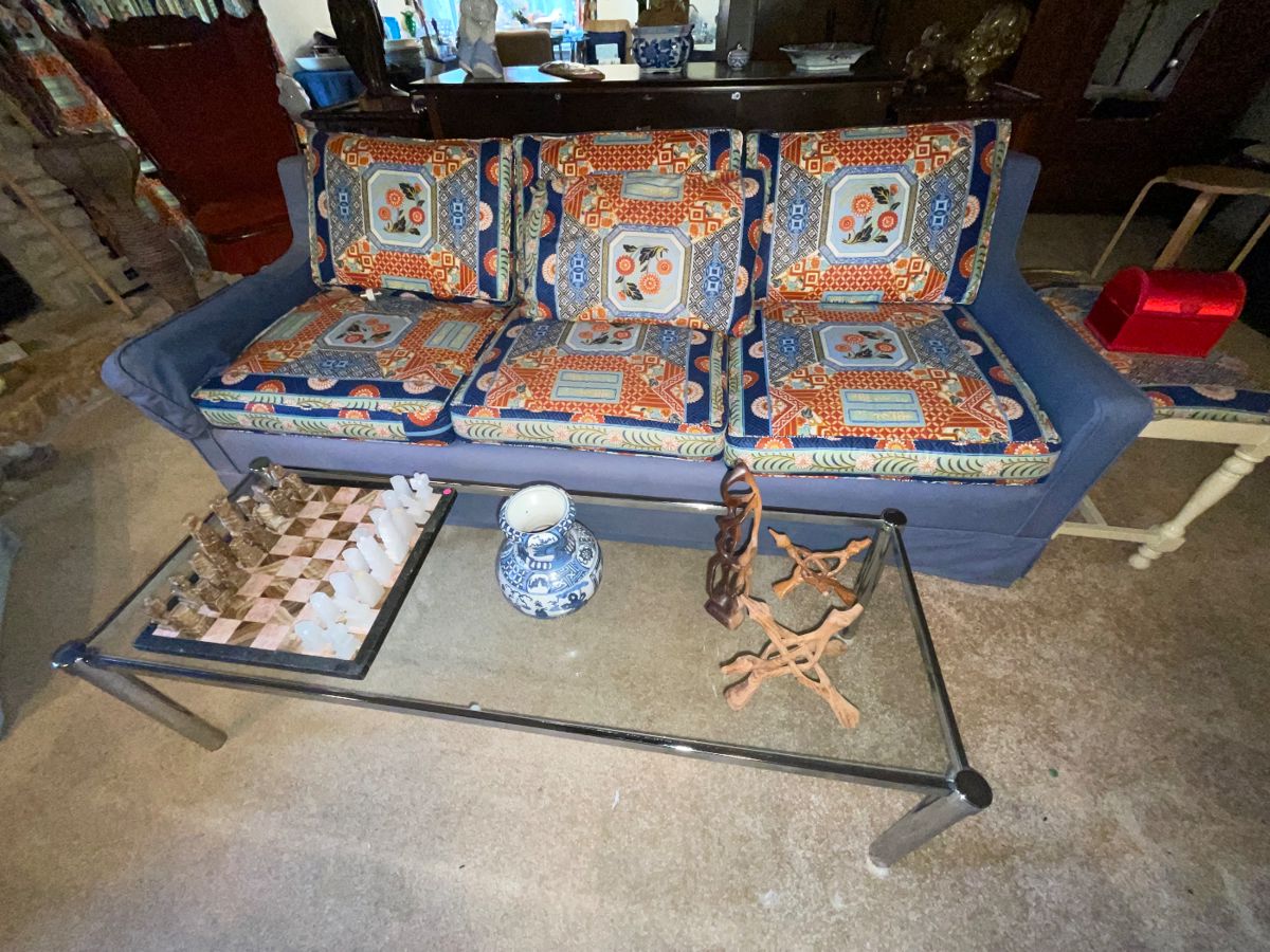 Blue Custom upholstered sofa in excellent condition - matching curtains to choose from. Glass coffee table with silver trim