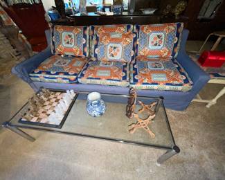 Blue Custom upholstered sofa in excellent condition - matching curtains to choose from.  Glass coffee table with silver trim