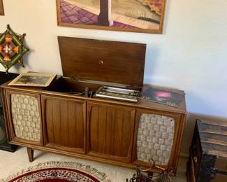 RCA Victor stereo console working but needs adjustments. Metal and bamboo magazine rack