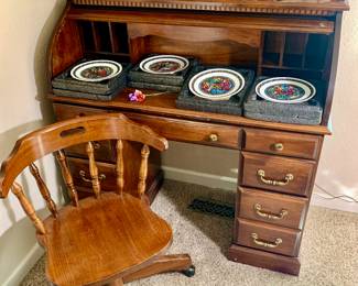 Roll top desk and vintage office chair. Vintage Xmas ornaments. Collectible plates